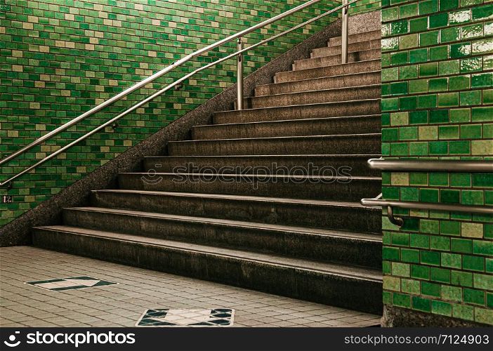 Tokyo subway stairway to station underground passage with retro green tiles wall
