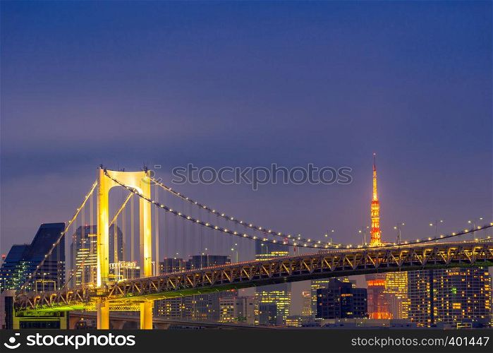 Tokyo Sunset with Tokyo tower and Rainbow bridge with Tokyo cityscape in background from Odaiba Japan.