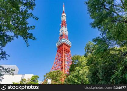 Tokyo Tower with blue sky in Tokyo. The structure is an Eiffel Tower-inspired lattice tower that is painted white and international orange to comply with air safety regulations.