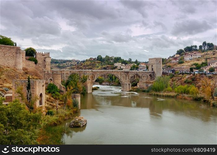 Toledo. Alcantara Bridge.. Alcantara Bridge or Puente de Alcntara . Stone arch bridge in the city Toledo. Spain. Castilla la Mancha.