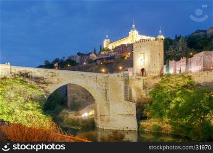 Toledo. Alcantara Bridge at night.. Alcantara Bridge or Puente de Alcntara . Stone arch bridge in the city Toledo. Spain. Castilla la Mancha.