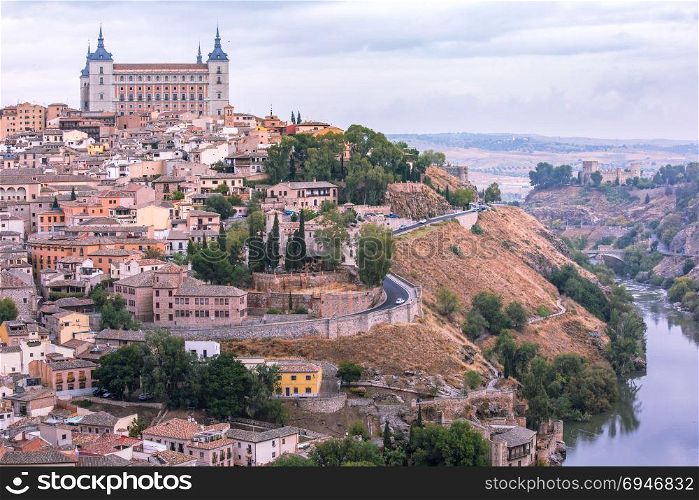 Toledo, Castilla La Mancha, Spain. Old city of Toledo with Alcazar and river Tajo at dusk, Castilla La Mancha, Spain