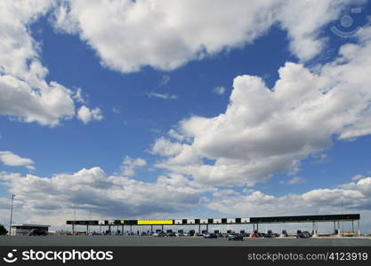 Toll motorway road in Europe in a sunny blue day with clouds