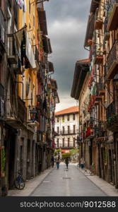 Tolosa, Spain - 29 April, 2022: narrow street with colorful buildings in the historic city center of Tolosa