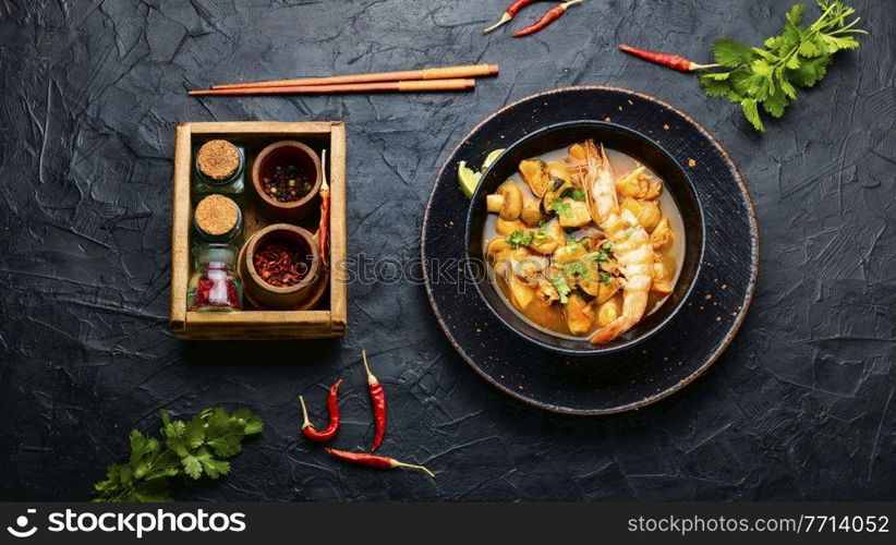 Tom yam kung spicy thai seafood soup in bowl. Tom yum soup with seafood and coconut milk