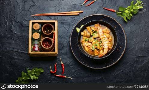 Tom yam kung spicy thai seafood soup in bowl. Tom yum soup with seafood and coconut milk