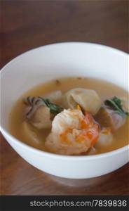 Tom Yum Goong - Thai hot and spicy soup seafood with shrimp in white bowl
