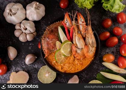 Tom yum with shrimp and crab with lime, chili, tomato, garlic, lemongrass and kaffir lime leaves.