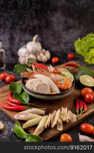 Tom yum with shrimp and crab with lime, chili, tomato, garlic, lemongrass and kaffir lime leaves. Selective focus.