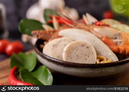 Tom yum with shrimp and crab with lime, chili, tomato, garlic, lemongrass and kaffir lime leaves. Selective focus.