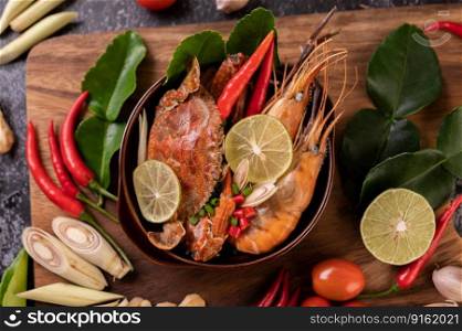 Tom yum with shrimp and crab with lime, chili, tomato, garlic, lemongrass and kaffir lime leaves.