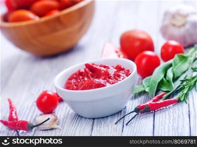 tomato and sauce on the wooden table