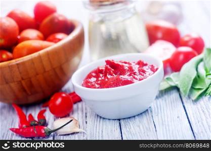 tomato and sauce on the wooden table