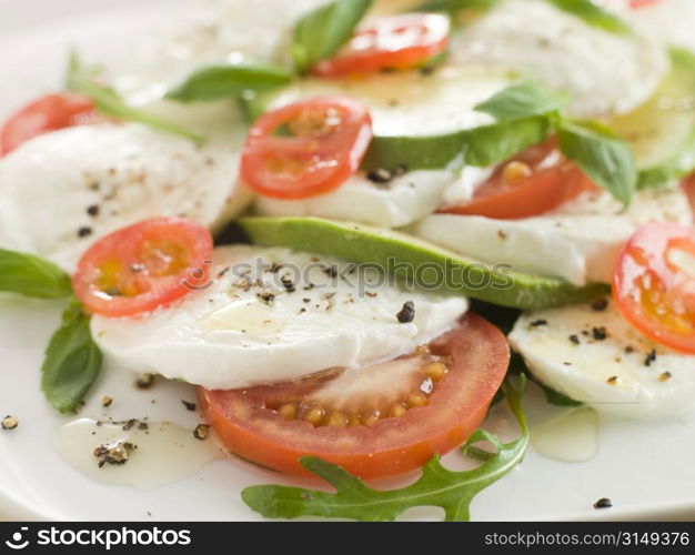 Tomato Avocado and Mozzarella Salad with Olive Oil and Black Pepper
