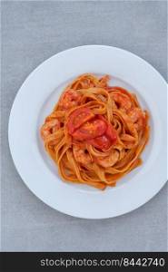 Tomato garlic shrimp tagliatelle pasta on the plate