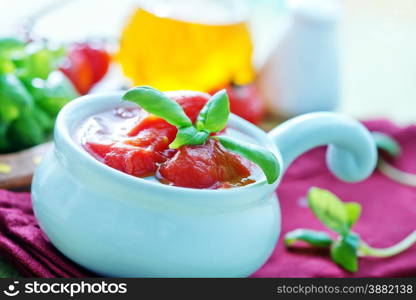 tomato in sauce , tomato in the bowl and on a table