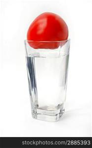 Tomato in the glass on white background