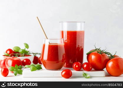 Tomato juice in a glass and fresh tomatoes