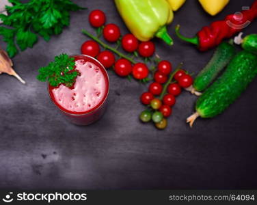 Tomato juice in a glass decorated with a sprig of parsley, top view