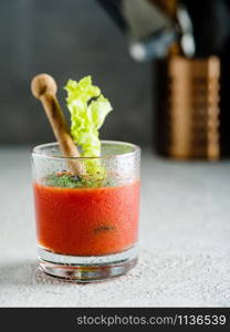 Tomato juice in glass with celery