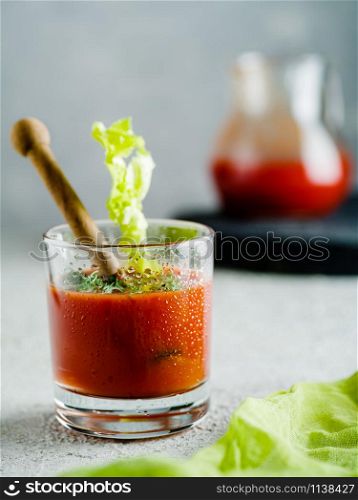 Tomato juice in glass with celery