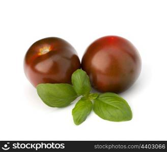 Tomato kumato and basil leaf isolated on white background