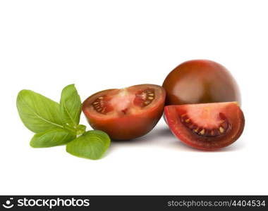 Tomato kumato and basil leaf isolated on white background