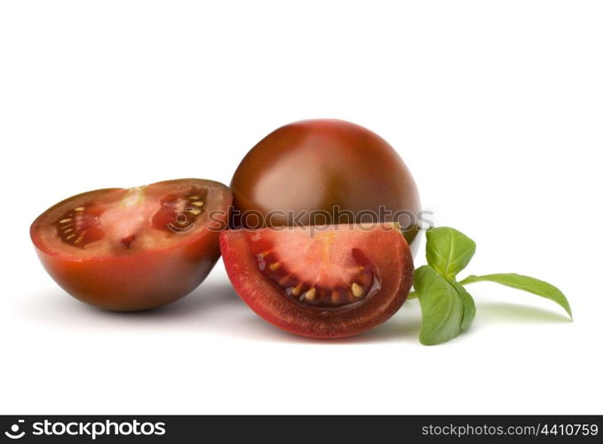 Tomato kumato and basil leaf isolated on white background