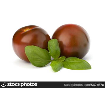 Tomato kumato and basil leaf isolated on white background