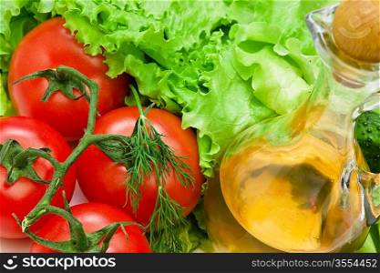 Tomato, lettuce salad and jug of vegetable oil