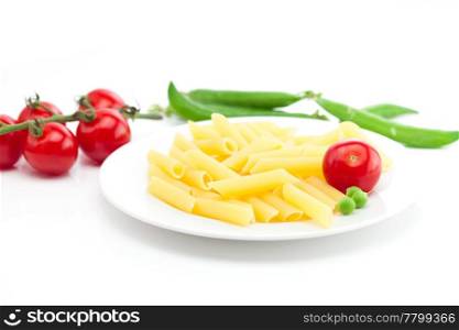 tomato, peas and pasta on a plate isolated on white