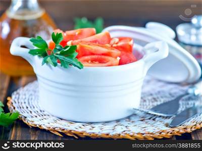 tomato salad in bowl on the wooden table