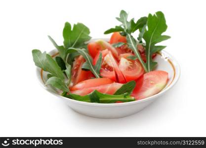 tomato salad with arugula in a white cup, studio isolated