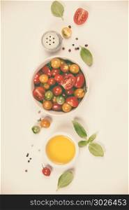Tomato salad with fresh tomatoes, basil and olive oil on white background with copyspace. Tomato salad with fresh tomatoes, basil and olive oil. Tomato salad with fresh tomatoes, basil and olive oil