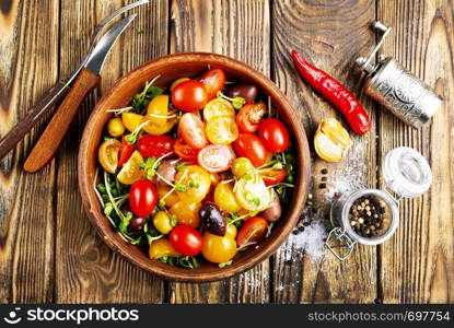 tomato salad with oil and olives in bowl