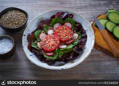Tomato salad with seeds radish spinach and lettuces healthy food. Tomato salad with seeds radish spinach lettuce
