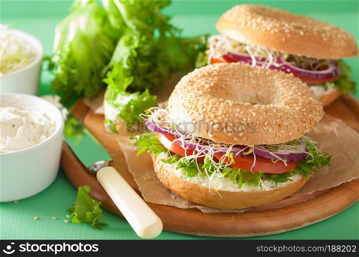 tomato sandwich on bagel with cream cheese onion lettuce alfalfa sprouts