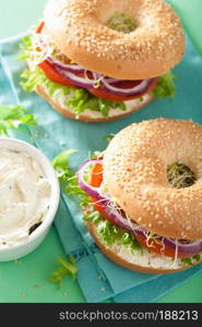 tomato sandwich on bagel with cream cheese onion lettuce alfalfa sprouts