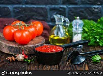 tomato sauce and fresh tomato on a table
