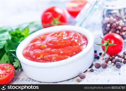 tomato sauce in bowl and on a table