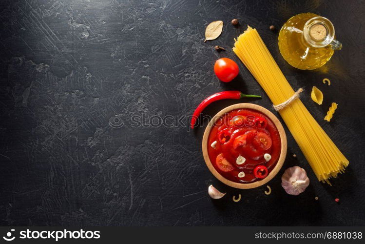 tomato sauce in bowl on black background texture