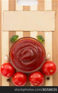 tomato sauce in bowl on wood cutting board