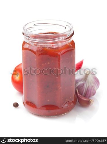 tomato sauce in glass jar on white background