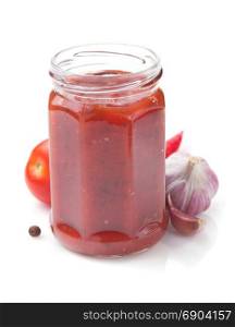 tomato sauce in glass jar on white background