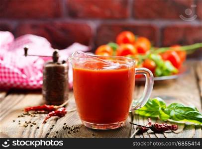 tomato sauce in glass jug and on a table