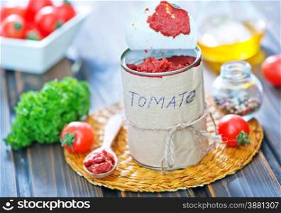 tomato sauce in metal bank and on a table