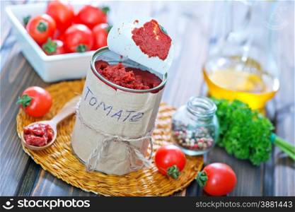 tomato sauce in metal bank and on a table