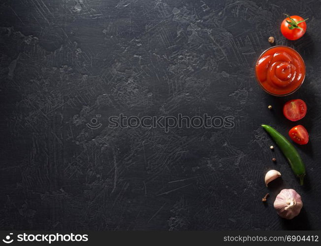 tomato sauce on black background texture