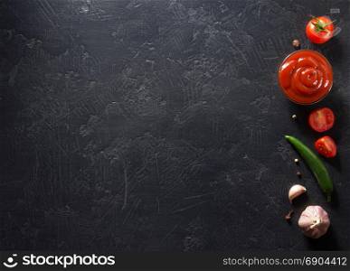tomato sauce on black background texture