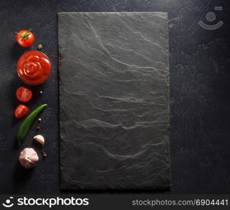 tomato sauce on black background texture